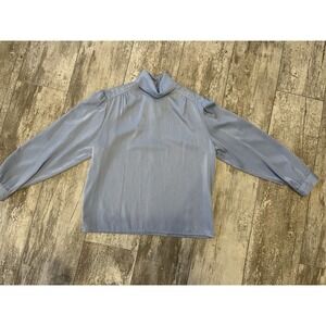 Vintage-style blue satin blouse‎ with long sleeves and a mock neck